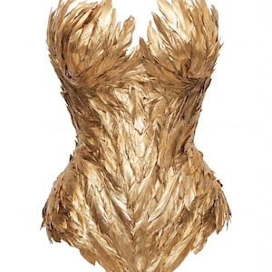 May include: A golden corset made of feathers. The feathers are arranged to create a structured, form-fitting silhouette. The corset has a sweetheart neckline and a defined waist, with a smooth, polished finish.