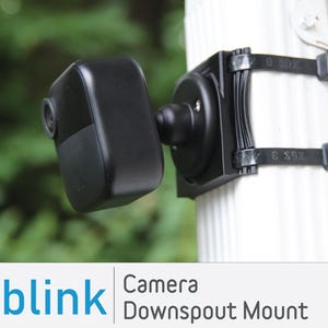 May include: A black Blink camera mounted on a downspout using black zip ties. The camera is angled downwards and the text "Camera Downspout Mount" is visible below the image.