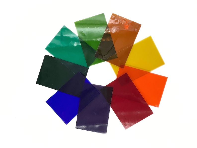 May include: A set of eight colored transparent sheets arranged in a circle. The colors are green, dark green, blue, purple, red, orange, yellow, and brown.