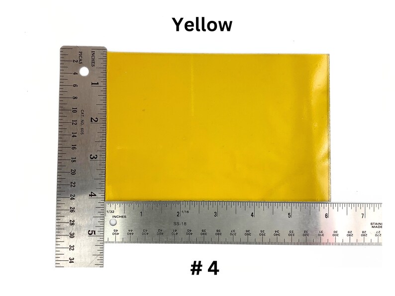 May include: A bright yellow square piece of paper, measuring approximately 4 inches by 6 inches, is shown next to a ruler. The paper is labeled "#4".