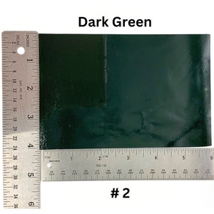 May include: A dark green leather sample with a ruler measuring 6 inches by 6 inches. The sample is labeled #2.