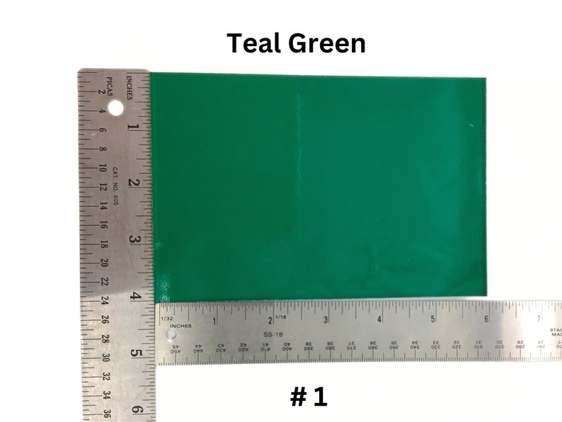 May include: Teal green vinyl sheet with a ruler for size reference. The sheet is approximately 6 inches by 4 inches. #1