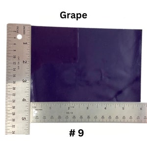 May include: A close-up of a dark purple vinyl sheet with a ruler measuring 5 inches by 6 inches. The sheet is labeled "Grape #9".