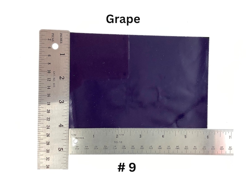 May include: A close-up of a dark purple vinyl sheet with a ruler measuring 5 inches by 6 inches. The sheet is labeled "Grape #9".