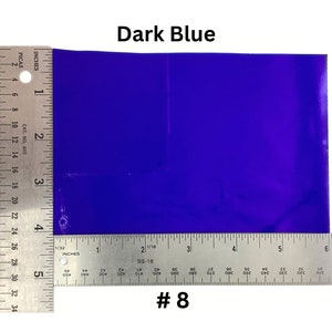 May include: A dark blue sheet of paper measured with a ruler. The ruler shows inches and picas. The paper is 5 inches by 6 inches. #8
