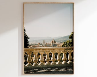 May include: A view of the city of Florence, Italy, from a stone balustrade. The iconic Duomo, with its distinctive dome, is visible in the distance. The cityscape is bathed in warm sunlight, creating a picturesque scene.
