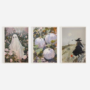 May include: Three framed paintings with Halloween themes. The first painting shows a white ghost in a field of pink flowers. The second painting shows white pumpkins in a field of green leaves. The third painting shows a witch in a black dress walking through a field with a full moon in the sky.