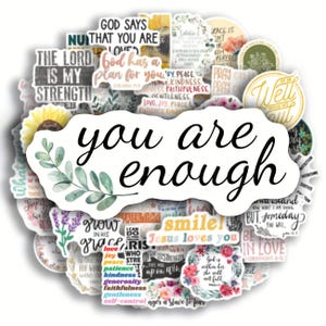May include: A selection of white stickers featuring motivational quotes and floral designs. The central sticker displays the words "you are enough" in cursive. Other stickers include phrases such as "The Lord is my strength" and "Jesus loves you."