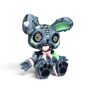 May include: A 3D-printed rabbit figurine in dark gray with light green accents, featuring button-style eyes, a stitched mouth with a protruding tongue, a light pink bow at the neck, and black paw pads on the feet, all with visible layer lines.