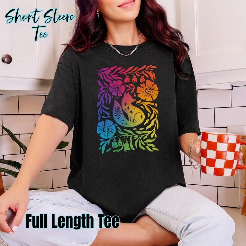 Black Shirts (Comfort Colors long or short sleeve or boxy tee, Gildan hoodie or crewneck sweatshirt or Next Level racerback tank) featuring Cottagecore Fox design in the subtle colors of the Gay Pride flag. LONG sleeves can be customized by adding on my sleeve customization listing in my shop.