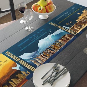 May include: A blue and yellow table runner with the text "Exodus from Egypt" and "Passover Haggadah" on it. The runner features illustrations of the parting of the Red Sea and the Israelites' journey out of Egypt.