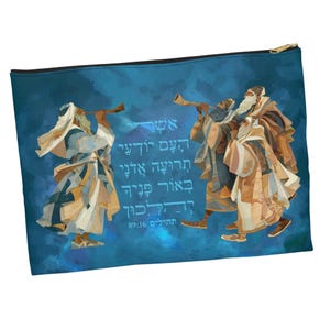 May include: A blue zippered pouch featuring an illustration of figures blowing horns, with text in Hebrew. The figures are dressed in robes, and the background is a gradient of blue hues. The pouch has a gold zipper.