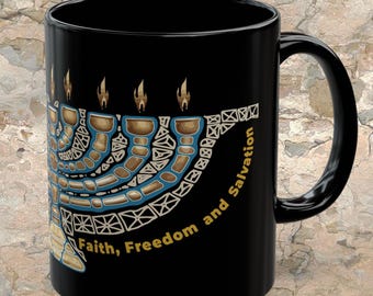 May include: A black ceramic mug featuring a stylized graphic of a menorah with gold and blue geometric patterns. The flames are depicted in gold. The text "Faith, Freedom and Salvation" is printed in gold lettering along the base of the menorah.