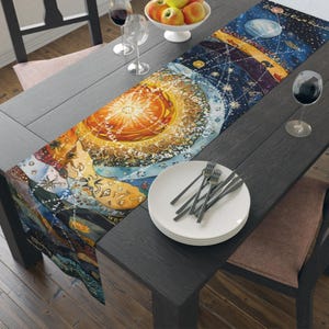 May include: A colorful table runner with a celestial design featuring planets, stars, and a sun-like center. The runner is placed on a dark wooden table, alongside plates, forks, wine glasses, and a bowl of apples. The artwork has a vintage, artistic style.