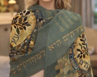 May include: A sage green scarf featuring a gold mosaic-style tree of life pattern and Hebrew text printed in gold. The design includes geometric tile motifs in shades of gold, brown, and blue, with a fringed edge and a soft, lightweight fabric texture.
