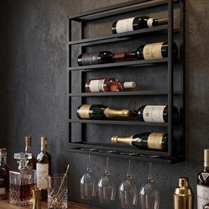 May include: A black metal wall-mounted wine rack featuring five horizontal shelves holding various wine bottles and a bottom rack for hanging four clear glass wine glasses. The rack is rectangular with a grid-like frame design.