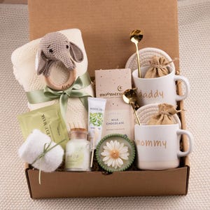 May include: A set of three ceramic mugs with a speckled, matte finish. The mugs are in shades of cream, light gray, and dark gray. Each mug has a simple, minimalist design, perfect for coffee or tea.