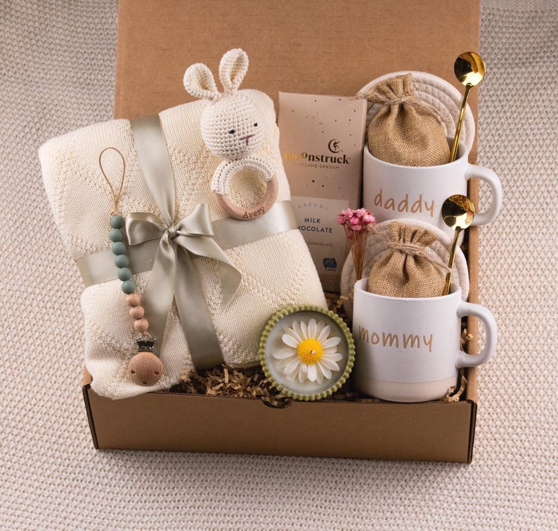 May include: A set of three ceramic mugs with a speckled, matte finish. The mugs are in shades of cream, light grey, and dark grey. Each mug has a simple, minimalist design, ideal for coffee or tea.