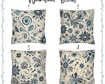 May include: Four decorative throw pillows with floral designs in shades of blue, gray, and cream. The pillows feature intricate patterns of flowers, leaves, and swirls. The text "Whimsical Blues" is displayed at the top.