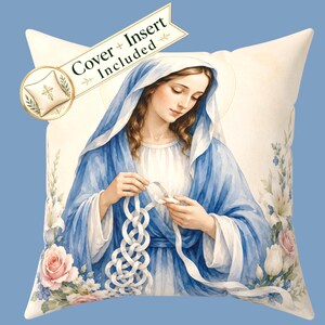 May include: A square throw pillow featuring a watercolour illustration of the Virgin Mary wearing a blue veil and robe, untying white knots with her hands. The design includes pink and white roses, and a banner stating Cover + Insert Included.