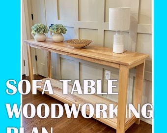 May include: A light wood sofa table with a lower shelf. The table has a simple design with straight legs and a rectangular top. The table is shown in a home setting with a lamp and decorative items on top.