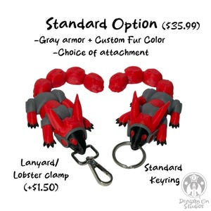 May include: Two red and gray scorpion-shaped keychains with a choice of attachments: a lobster clasp or a standard keyring. The text "Standard Option ($35.99)" is at the top of the image. The text "Lanyard/Lobster clamp (+$1.50)" is below the keychain with the lobster clasp. The text "Standard Keyring" is below the keychain with the keyring.