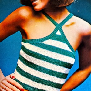 May include: A green and white striped halter top with a criss-cross strap design.