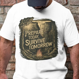 May include: White t-shirt with a graphic of a forest scene with a campfire and the text "PREPARE TODAY, SURVIVE TOMORROW".