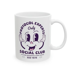 May include: White ceramic mug with a purple design. The design features a cartoon face with the text "Protocol Experts Only" and "Social Club" with the tagline "If it's not documented it didn't happen" and the phone number "555-1572".