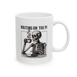 May include: White ceramic coffee mug with a black and white illustration of a skeleton holding a cup of coffee. The text "WAITING ON THE PI" is printed on the mug.