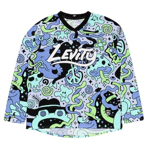 May include: A long-sleeved jersey with a V-neck collar. The jersey features a light blue background with a repeating pattern of cartoonish doodles in black, green, and blue. The word "LEVITY" is written across the chest in white.