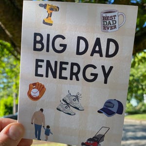 May include: A card with the text "BIG DAD ENERGY" and illustrations of a drill, coffee mug, baseball glove, sneakers, baseball cap, lawnmower, and a father and child walking.