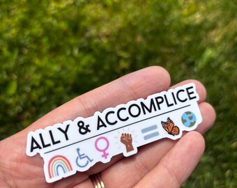 May include: A rectangular white sticker with the black text ALLY & ACCOMPLICE. Below the text are colorful icons including a rainbow, a wheelchair symbol, a female gender symbol, a raised fist, an equals sign, a monarch butterfly, and a globe.