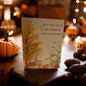 May include: A card with an illustration of a fall scene with a pumpkin patch and a question: "Will you go to the pumpkin patch with me?" with a checkbox for "yes" and "no".