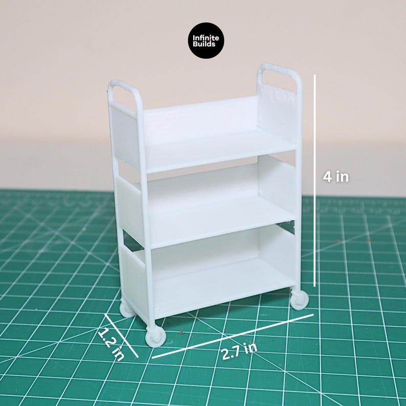 May include: White three-tiered rolling cart with wheels, measuring 4 inches tall, 2.7 inches wide, and 1.2 inches deep.