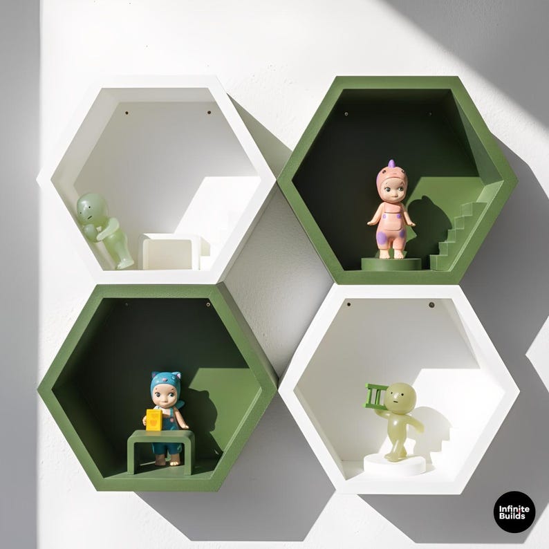 May include: A set of four hexagonal wall shelves in white and green, each housing a small figurine. The shelves are arranged in a cluster, with the figurines in various poses. The shelves are mounted on a white wall.