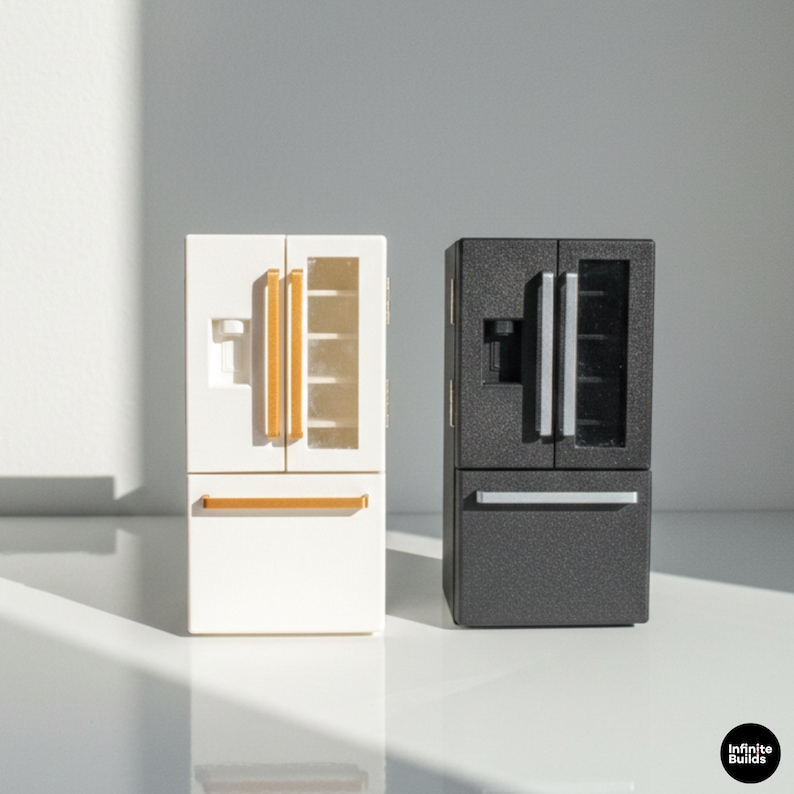 May include: Miniature white and black side-by-side refrigerators. The white refrigerator has gold-colored handles and a water dispenser. The black refrigerator has silver-colored handles and a water dispenser. Both have a bottom freezer drawer.