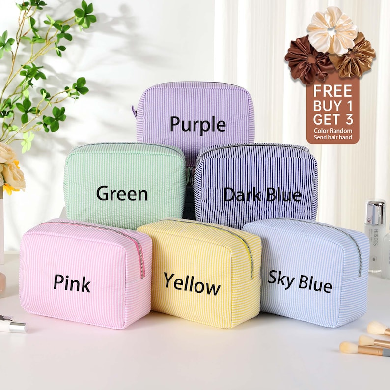 May include: Six striped zippered pouches in different colors: purple, green, dark blue, yellow, sky blue, and pink. The pouches are arranged in a row, with the purple pouch at the top and the pink pouch at the bottom. The text "FREE BUY 1 GET 3" is visible in the top right corner of the image.