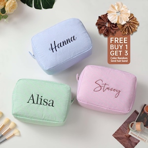 May include: Three personalized striped makeup bags in blue, green, and pink with the names Hanna, Alisa, and Stacey embroidered on them.  Free buy one get three offer with a random color hair band.