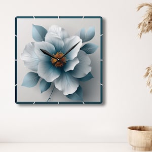 May include: Square wall clock with a blue and white floral design. The clock face is white with black hands and a gold center.