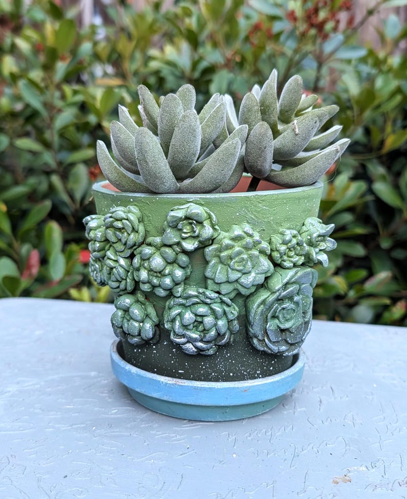 May include: A set of three ceramic mugs with a speckled, matte finish. The mugs are in shades of cream, light gray, and dark gray. Each mug has a simple, minimalist design, perfect for coffee or tea.