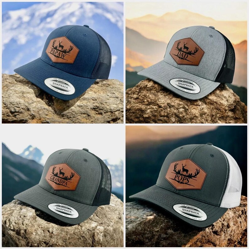 May include: Four snapback caps with mesh backs and leather-like hexagonal patches. The patches feature a deer silhouette, antlers, and the text PAPAW, DAD, GRANDPA, or POPS. The caps are navy, heather gray, dark gray, and charcoal gray.