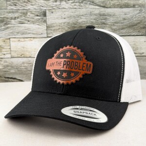 I am the Problem Hat – Engraved Leatherette Patch Trucker Snapback