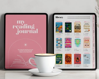 May include: A pink tablet with the text "my reading journal" on the screen. The tablet is next to another tablet with a reading list on the screen. The reading list includes titles like "Atomic Habits", "First, We Make the Rules", and "Outlive".