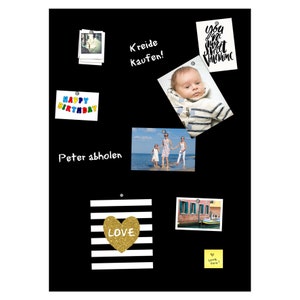 May include: A black magnetic board with various items pinned to it, including photos, a heart with the word "LOVE" on it, and a note that says "Kreide Kaufen!" (German for "Buy Chalk!").