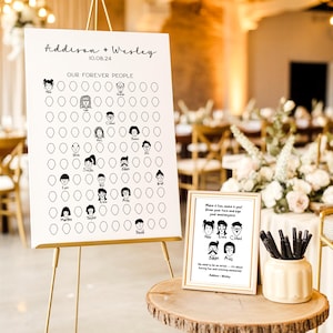 Peut inclure: Un panneau de mariage blanc sur un chevalet doré avec les noms "Addison + Wesley" et la date "10.08.24". Le panneau comporte une grille de visages et les mots "OUR FOREVER PEOPLE". Un petit panneau encadré et un vase de stylos sont sur une table en bois.