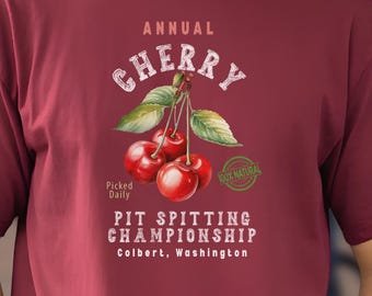 Camiseta unisex del Festival de Escupir Huesos de Cereza: Camiseta de algodón