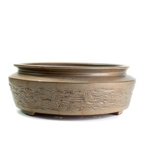 May include: A round, low-profile ceramic bonsai pot with a smooth, flared rim and a textured, bark-like finish around the exterior. The vessel features a muted, earthy brown glaze and is supported by small, integrated feet at the base.