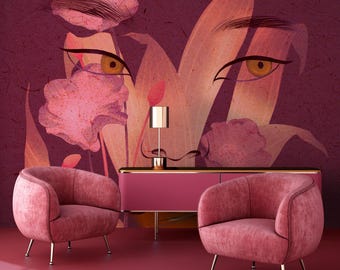May include: Two pink velvet armchairs with gold legs in front of a pink cabinet with a gold trim. The wall behind the furniture features a large abstract floral design with a woman's face and eyes.