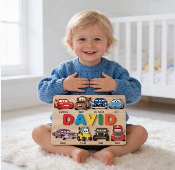 A wooden name puzzle where each letter is a little car — Lightning McQueen-themed personalization makes it a genuinely charming, play-meets-keepsake first birthday gift.